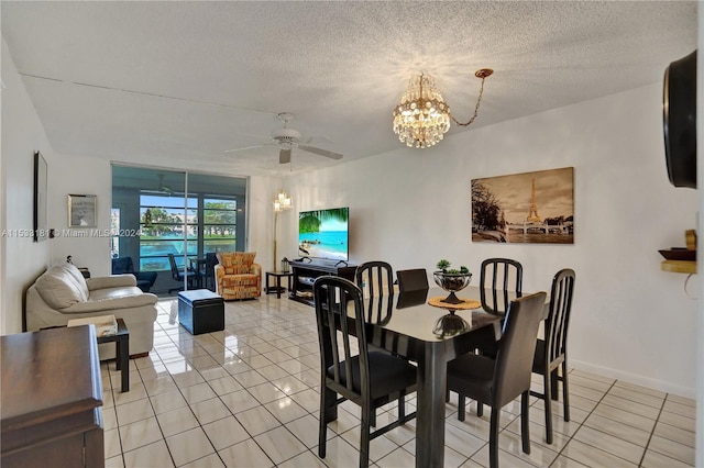 dining space featuring a textured ceiling, ceiling fan with notable chandelier, and light tile floors