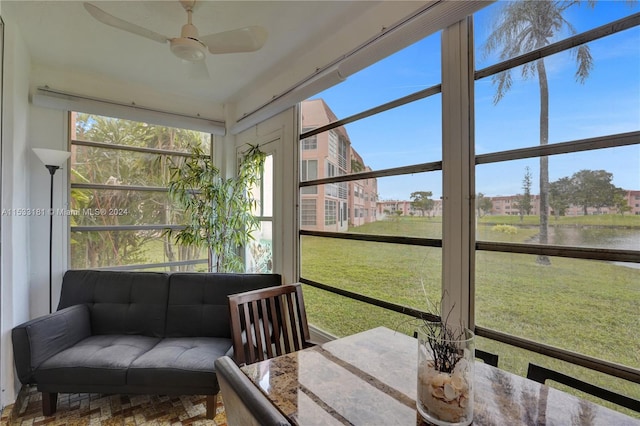 sunroom / solarium featuring ceiling fan