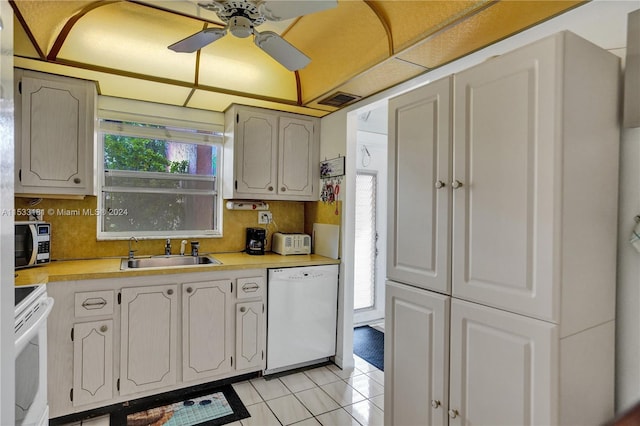 kitchen featuring white appliances, ceiling fan, light tile floors, sink, and tasteful backsplash