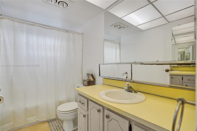 bathroom with vanity, tile flooring, and toilet