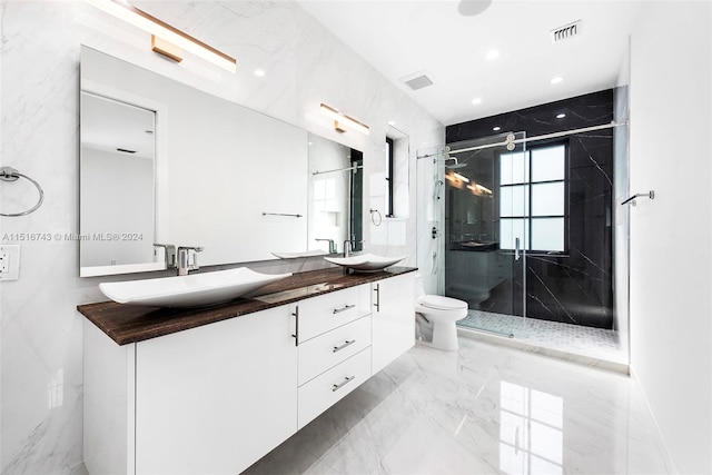 bathroom with a shower with door, vanity, and toilet