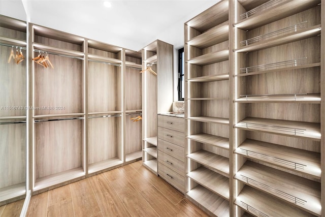 walk in closet featuring light hardwood / wood-style flooring