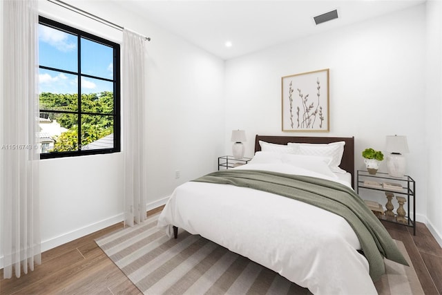 bedroom with wood-type flooring