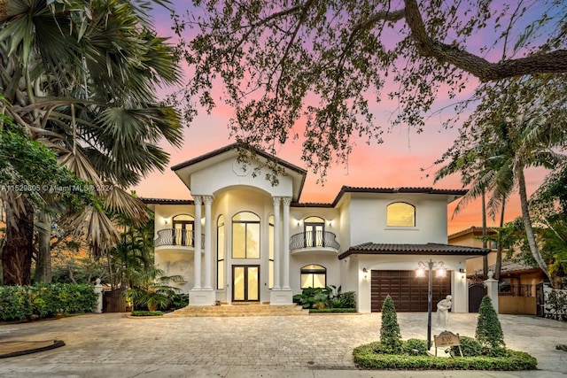 mediterranean / spanish home featuring french doors and a garage