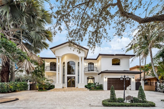 mediterranean / spanish home with a balcony and a garage