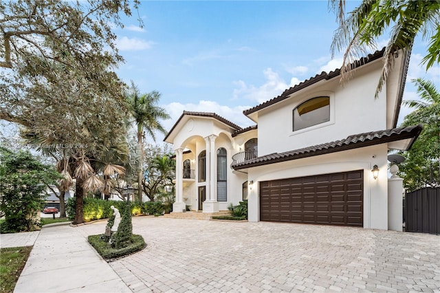 mediterranean / spanish-style home with a garage