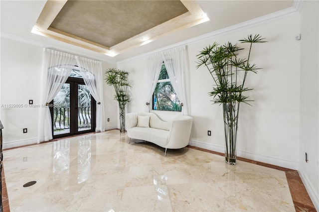 living area featuring a raised ceiling, french doors, light tile floors, and ornamental molding