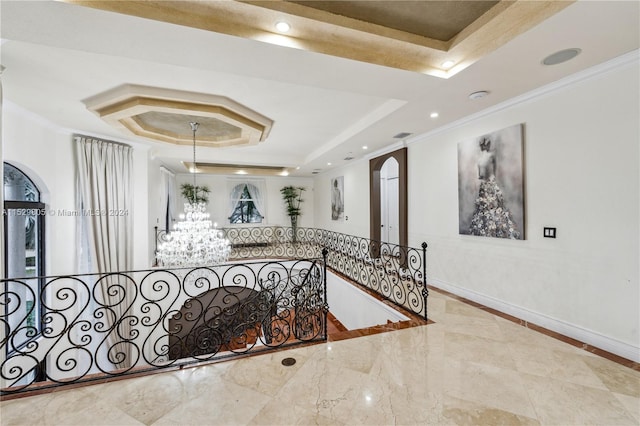 interior space featuring light tile floors, an inviting chandelier, ornamental molding, and a tray ceiling