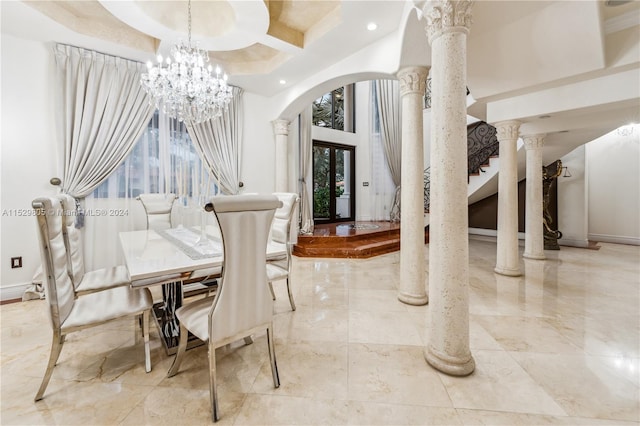 dining room featuring coffered ceiling, decorative columns, light tile floors, and an inviting chandelier