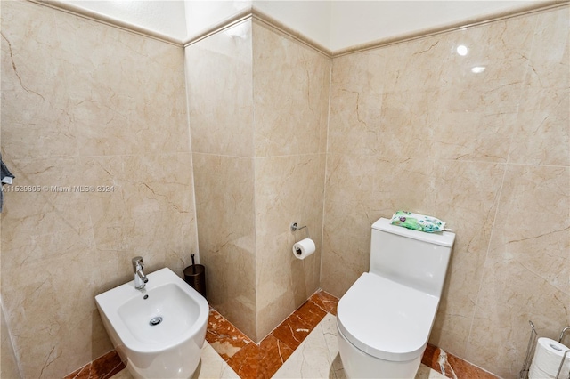 bathroom featuring a bidet, tile floors, toilet, and tile walls