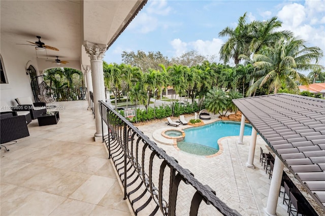 balcony featuring a patio, a fenced in pool, and ceiling fan