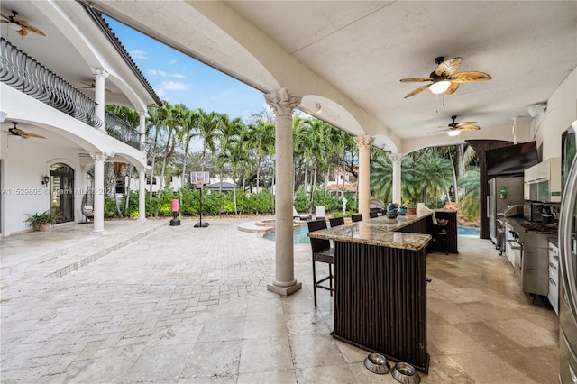 view of terrace featuring area for grilling and ceiling fan