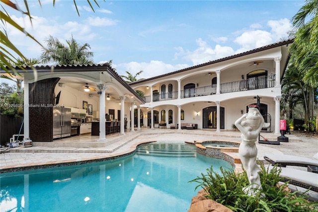 view of swimming pool with a patio, an in ground hot tub, and ceiling fan