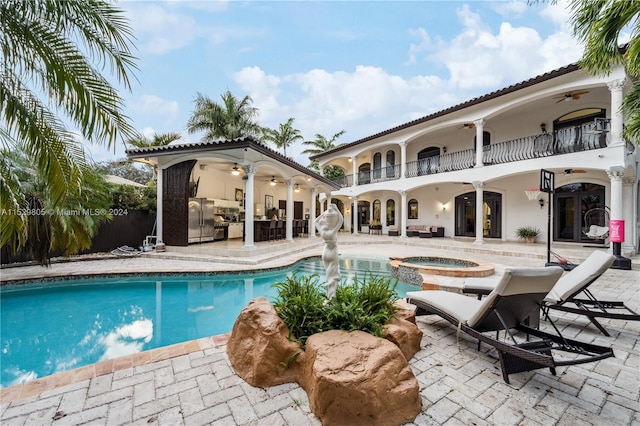 view of swimming pool featuring an in ground hot tub, ceiling fan, and a patio