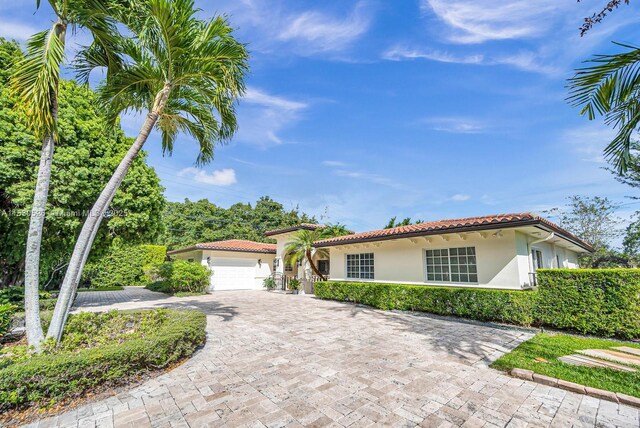 mediterranean / spanish home with a garage