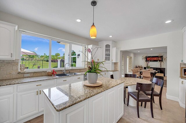 kitchen featuring tasteful backsplash, stainless steel appliances, white cabinets, and stone counters