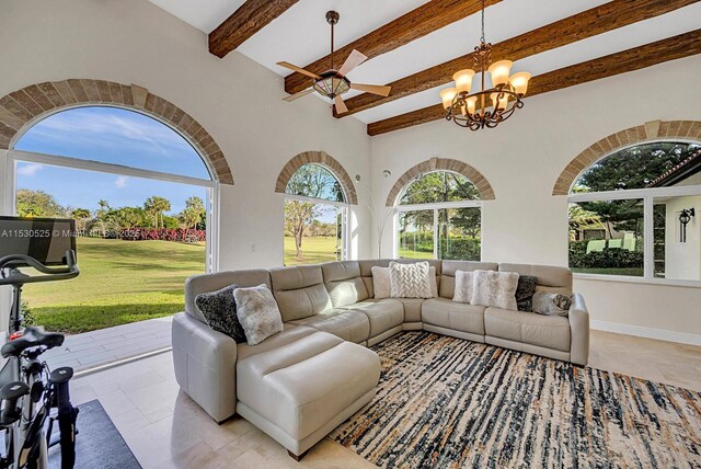 living room with beamed ceiling, ceiling fan with notable chandelier, and french doors