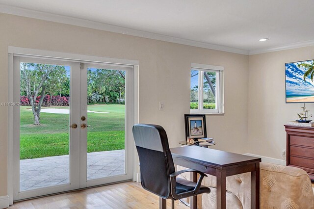 office space featuring crown molding, light wood-type flooring, and french doors