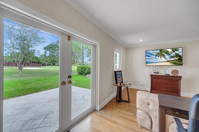 office featuring crown molding, light hardwood / wood-style flooring, and french doors