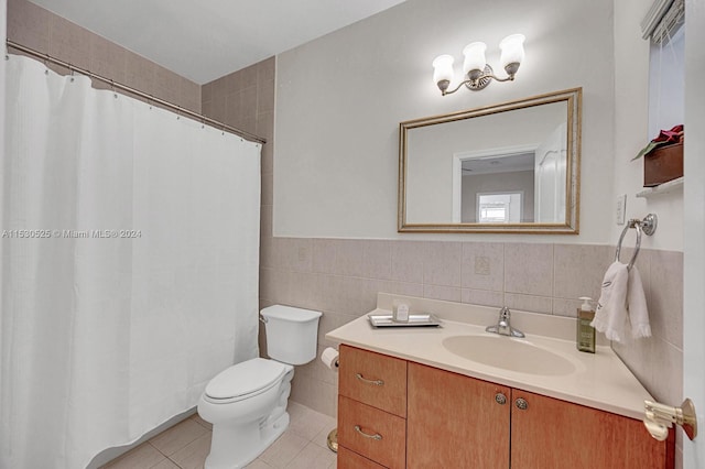 bathroom featuring tile walls, vanity, tile patterned floors, and toilet