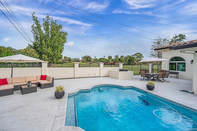 view of swimming pool with an outdoor living space and a patio area