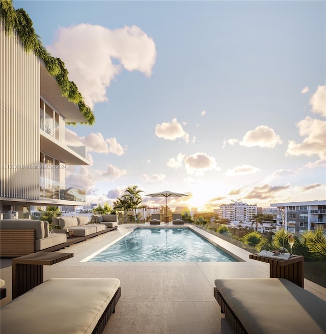 pool at dusk with a patio area