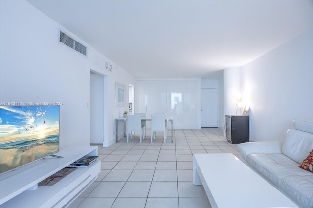 living room with light tile patterned flooring and visible vents