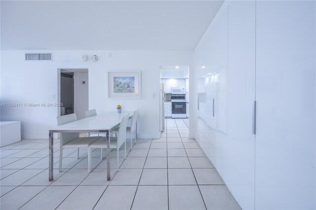 interior space featuring walk in shower and tile flooring