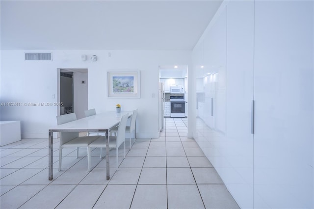 dining space featuring visible vents and light tile patterned floors