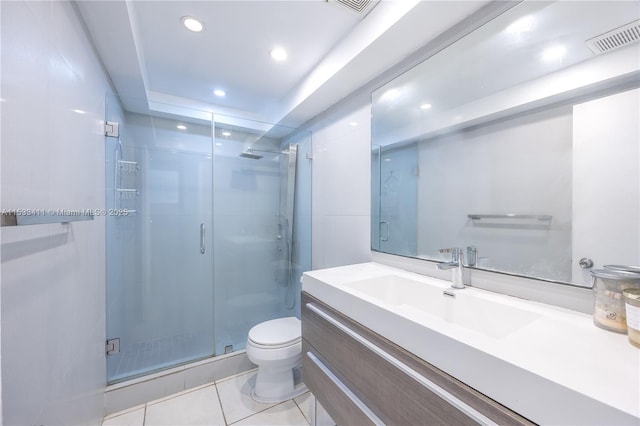 full bathroom featuring tile patterned flooring, toilet, vanity, visible vents, and a stall shower