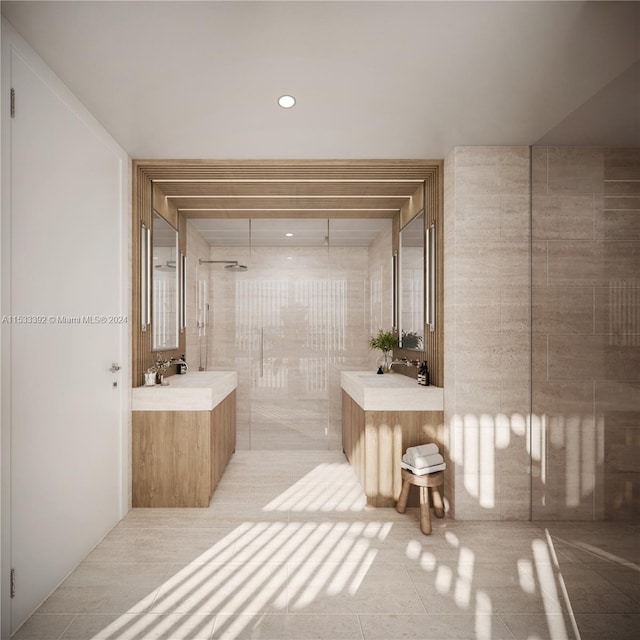 bathroom with tile floors, double vanity, a shower, and tile walls