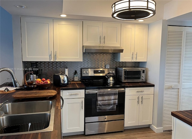 kitchen with white cabinets, sink, light hardwood / wood-style floors, and stainless steel electric stove