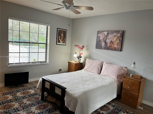 unfurnished bedroom featuring hardwood / wood-style floors, a textured ceiling, ceiling fan, and access to exterior