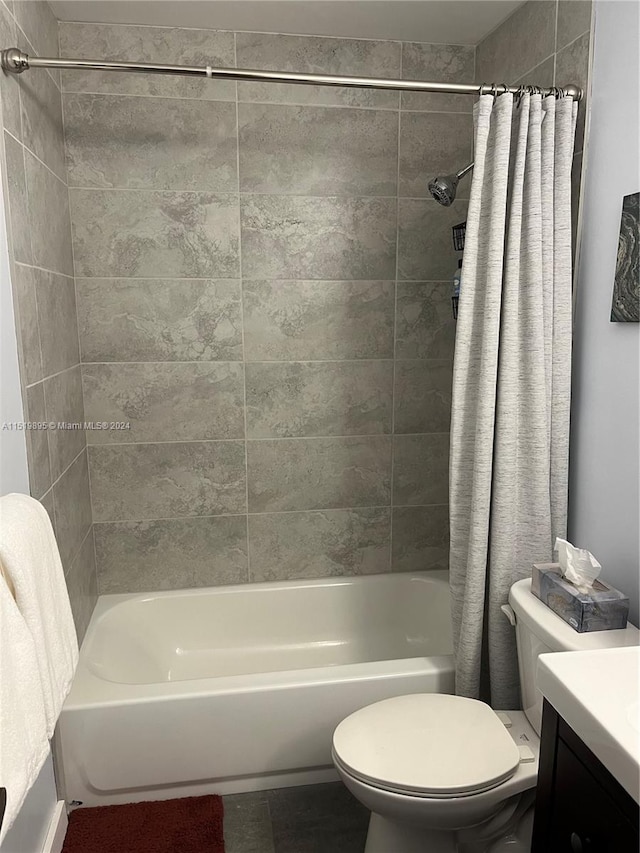 bathroom featuring walk in shower, tile flooring, large vanity, and toilet