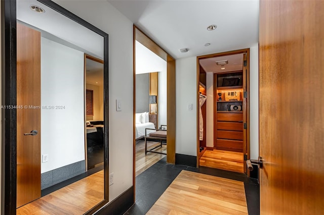 corridor featuring hardwood / wood-style floors