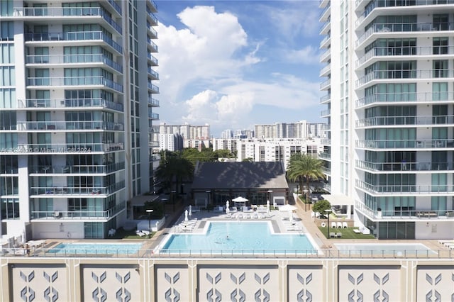 view of swimming pool featuring a hot tub