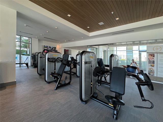 exercise room with wooden ceiling and expansive windows