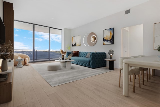 living room with expansive windows and light wood-type flooring