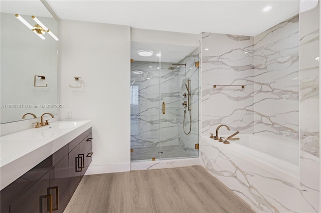 bathroom with hardwood / wood-style floors, separate shower and tub, and oversized vanity