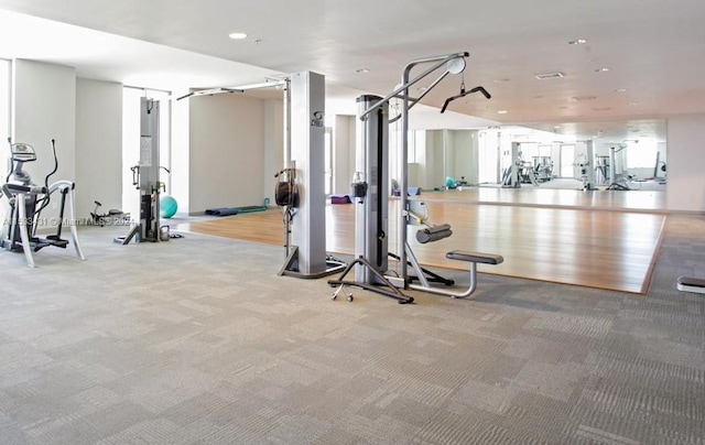 exercise room with light colored carpet