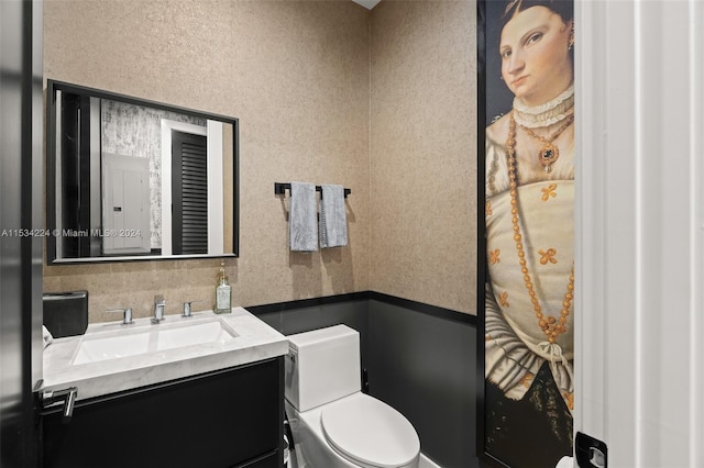 bathroom featuring vanity, backsplash, and toilet