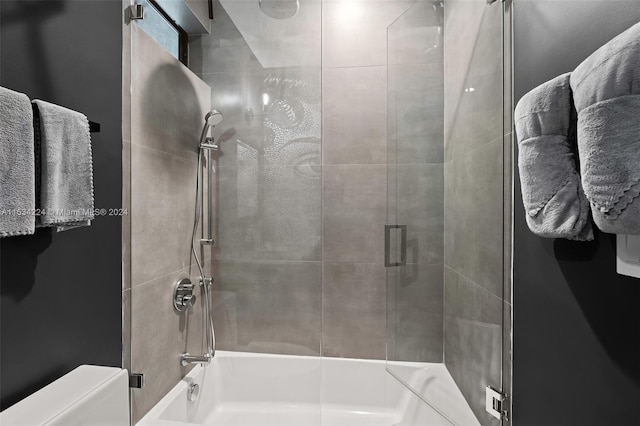 bathroom featuring combined bath / shower with glass door and toilet