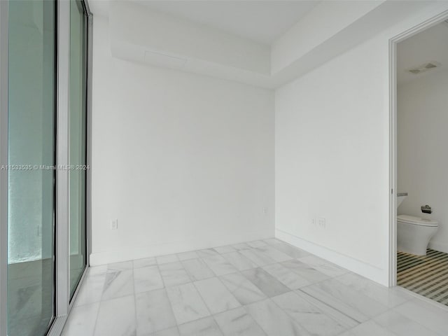 spare room with light tile floors