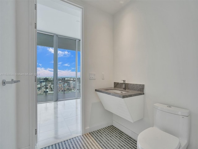 bathroom with sink, tile flooring, and toilet