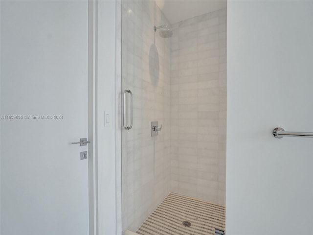 bathroom featuring a shower with door