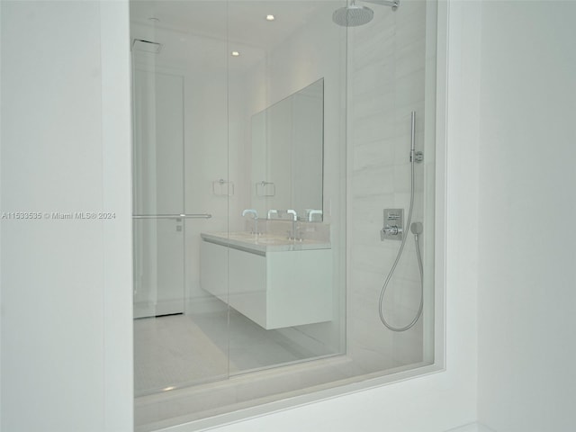 bathroom with vanity and tiled shower