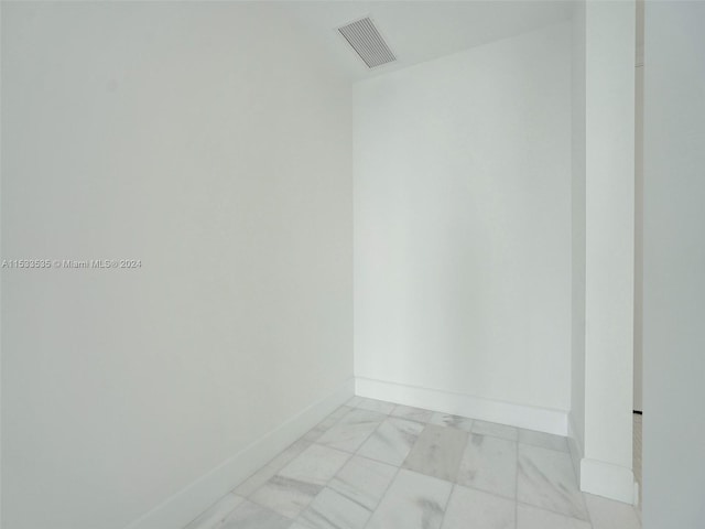 unfurnished room with light tile floors