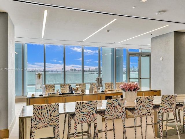 interior space with a kitchen breakfast bar and a water view