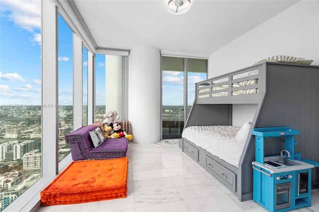 bedroom with expansive windows, wooden walls, and multiple windows