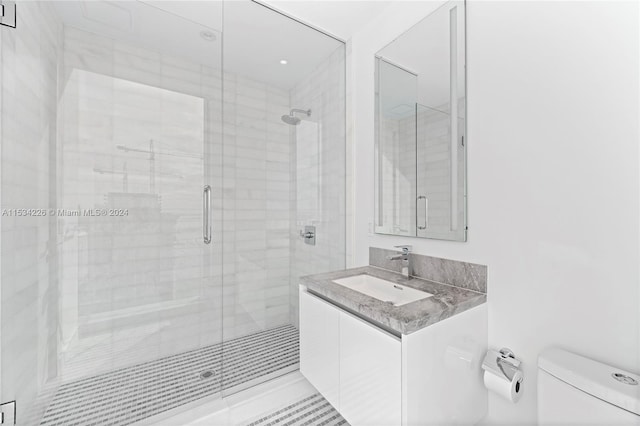 bathroom featuring walk in shower, vanity, and toilet